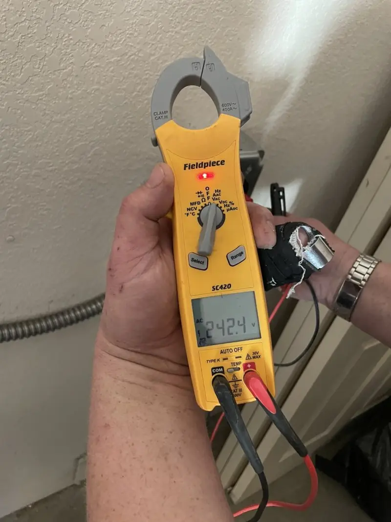 Voltage testing with clamp meter during Ceiling Fan Installation in Goulding